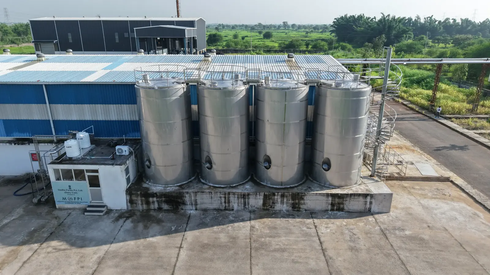Tank facility beside a blue and white building